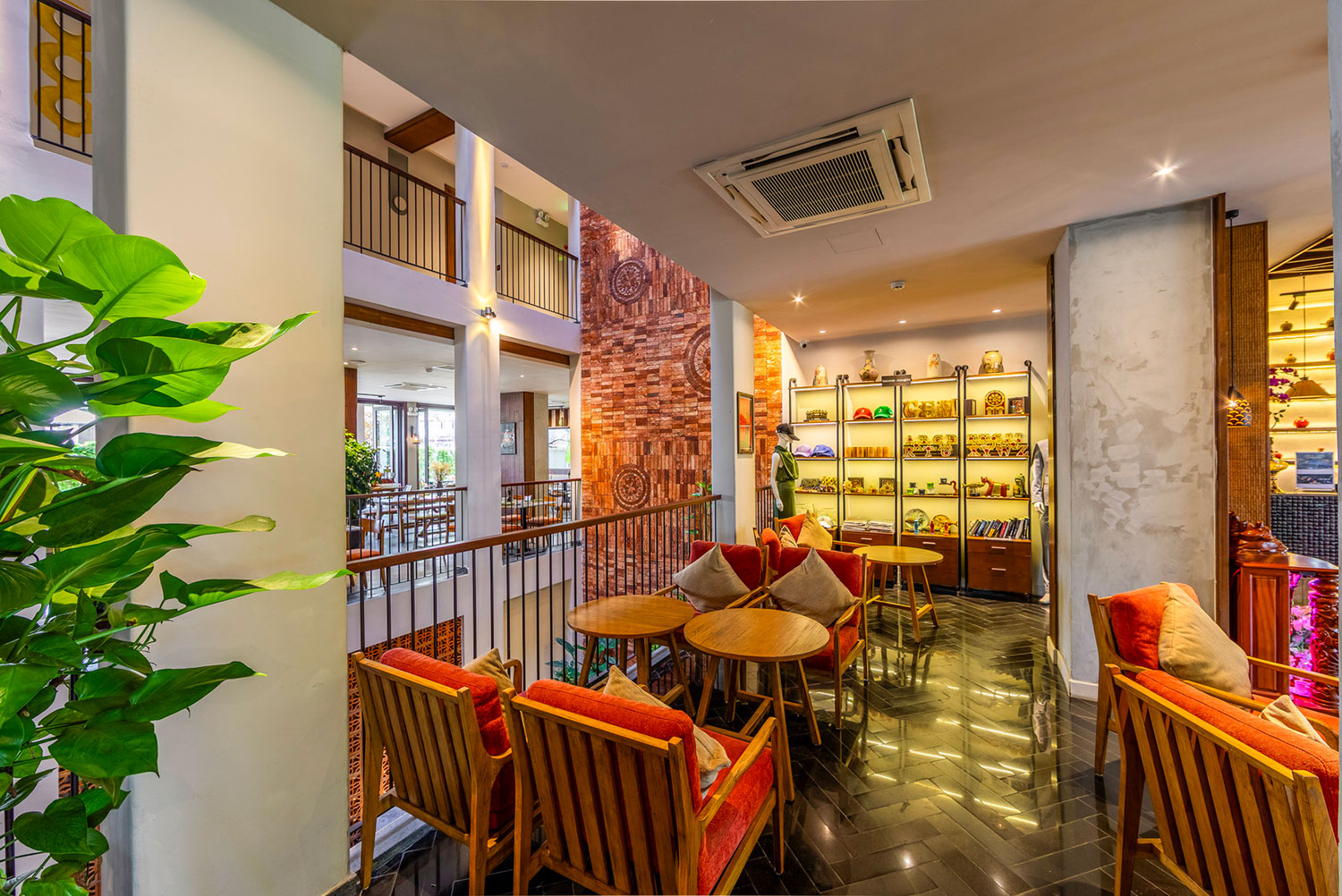 Souvenir displays and a welcoming seating area at Little Gem Hoi An
